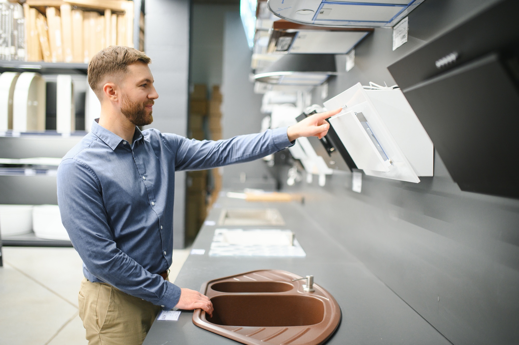 A man chooses a cooker hood in a store