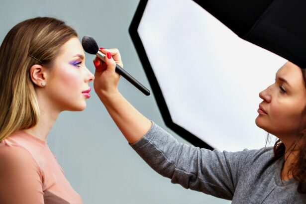 Backstage of the photo shoot: Make-up artist applies makeup on beautiful white model.