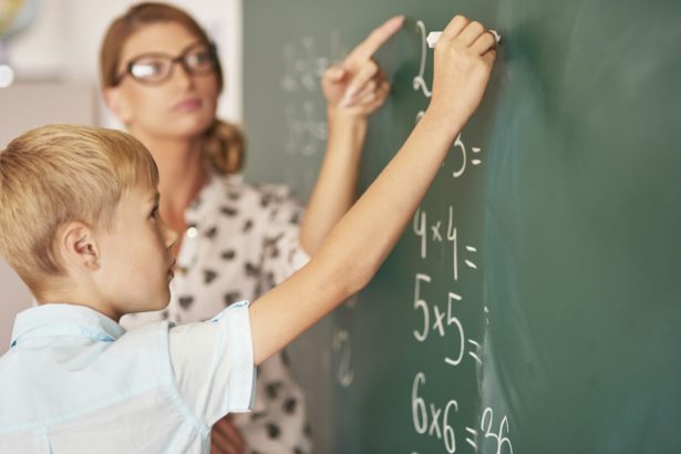 Teacher trying to help boy understand the Maths